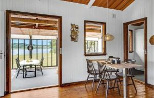 a dining room with a table and chairs and a window at Awesome Home In Roskilde With House Sea View in Roskilde