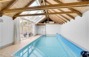 an indoor swimming pool with a glass roof at 4 Bedroom Cozy Home In Hvide Sande in Havrvig