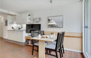 a kitchen and dining room with a table and chairs at Lejl, 226 St, in Fanø