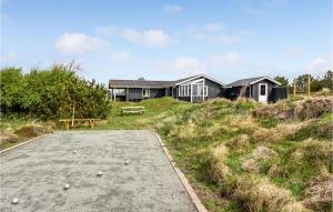 una casa seduta in cima a una collina ricoperta di erba di Holiday Home Fanø 54 a Sønderho