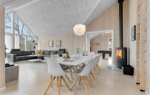 a dining room and living room with a table and chairs at Four-Bedroom Holiday Home In Odder in Odder