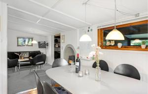 a dining room with a white table and chairs at Beautiful Home In Nex With Kitchen in Neksø