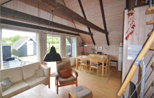 a living room with a couch and a dining room at 3 Bedroom Beautiful Home In Glesborg in Bønnerup Strand