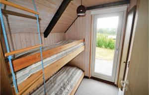 a room with two bunk beds in a tiny house at 3 Bedroom Beautiful Home In Glesborg in Bønnerup Strand