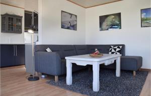 a living room with a couch and a table at Holiday Home Mellemvang in Kirke-Hyllinge