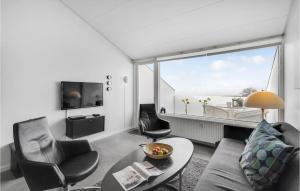 a living room with a couch and chairs and a large window at Feriecenter Klinten in Faaborg