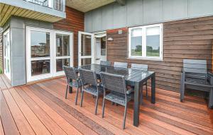 a black table and chairs on a wooden deck at Stunning Home In Faaborg With 4 Bedrooms, Sauna And Wifi in Faaborg