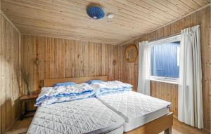 a bedroom with a bed in a wooden wall at 3 Bedroom Pet Friendly Home In Vig in Vig