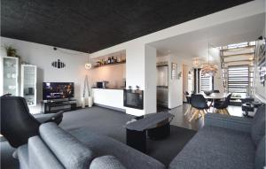 a living room with a couch and a table at Stunning Apartment In Rm With Wifi in Havneby