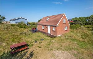 a house on top of a hill with a bench at Awesome Home In Nrre Nebel With Kitchen in Nymindegab