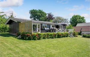 a small house with a lawn in front of it at Beautiful Home In Vordingborg With House Sea View in Bakkebølle Fredskov