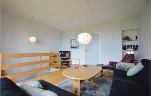 a living room with a table and a couch at Holiday Home Vadehavsvej Højer V in Emmerlev