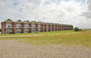 a large building with a field in front of it at Nice Home In Hjer With Kitchen in Emmerlev