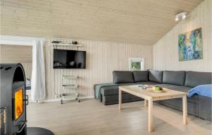 a living room with a couch and a table at Awesome Home In Hadsund With Sauna in Hadsund