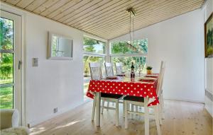 a dining room with a red table with white polka dots at 2 Bedroom Awesome Home In Vordingborg in Vordingborg