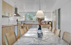 a kitchen with a table with a bottle of wine at Imagine in Bedegård +20 photos