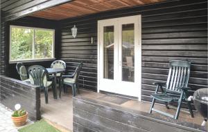 a porch with chairs and a table and a door at Two-Bedroom Holiday Home In Ansager in Ansager +9 photos