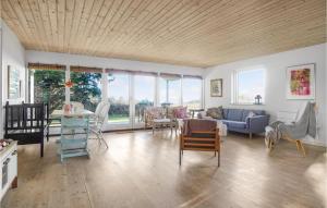 ein Wohnzimmer mit einem Sofa und Stühlen in der Unterkunft Stunning Home In Frevejle With House Sea View in Fårevejle