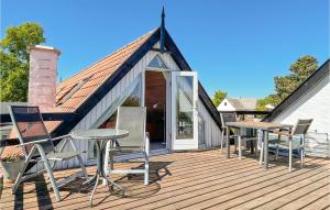 a wooden deck with chairs and a table on it at Beautiful Apartment In Nex With Wifi in Neksø