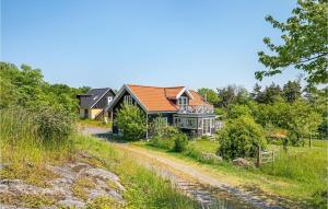 a house on a hill with a dirt road at Beautiful Home In Nex With Wifi in Bodilskirke