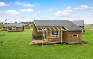 a house with a solar roof on a grass field at 1 Bedroom Awesome Home In Kolding in Kolding