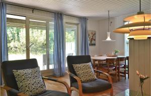 BjerregårdにあるGorgeous Home In Hvide Sande With Wifiのリビングルーム(テーブル、椅子付)、ダイニングルーム