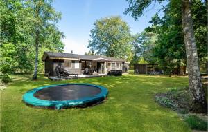 a house with a pool in the yard at Stunning Home In Ebeltoft With 3 Bedrooms And Wifi in Øksenmølle