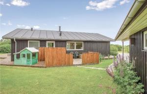a house with a wooden fence and a yard at Awesome Home In Vinderup With Wifi in Vinderup