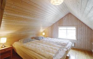 a bedroom with a large bed in a wooden ceiling at Tefres in Snogebæk