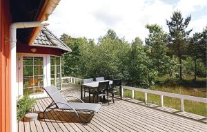 a deck with a table and chairs on a house at Tefres in Snogebæk +10 photos
