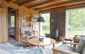 sala de estar con mesa y chimenea en Stunning Home In Fars With Wifi en Hvalpsund