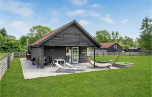 a house with a patio with a hammock in the yard at Awesome Home In Dragr With 2 Bedrooms And Wifi in Dragør