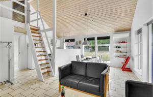a living room with a couch and a staircase at Awesome Home In Dragr With 2 Bedrooms And Wifi in Dragør