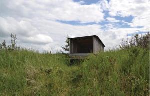 a small shack sitting on top of a grassy hill at Awesome Home In Hirtshals With Sauna in Hirtshals