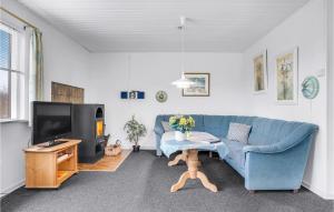 a living room with a blue couch and a tv at Stunning Home In Tarm With 2 Bedrooms And Wifi in Tarm