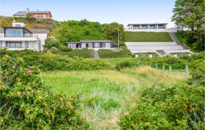 a house sitting on top of a lush green field at Two-Bedroom Holiday Home In Ebeltoft in Ebeltoft