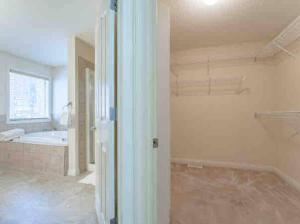 an empty room with a bathroom with a tub at 2500 sq house in Springbank Hill BL 261818 in Calgary