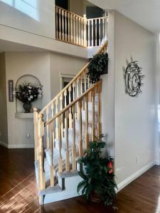 a staircase with a christmas tree in a living room at 2500 sq house in Springbank Hill BL 261818 in Calgary