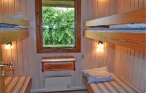 a room with two bunk beds and a window at 2 Bedroom Cozy Home In Hemmet in Hemmet