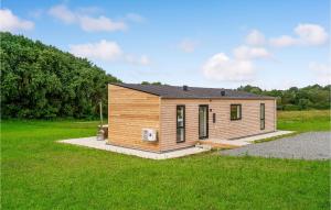 a small wooden cabin in a grassy field at Amazing Home In Spttrup With Wifi in Lihme