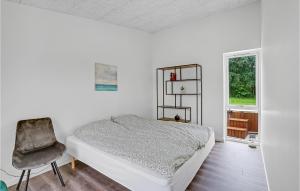a white bedroom with a bed and a chair at Amazing Home In Spttrup With Wifi in Lihme