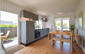 a kitchen with a table and a dining room at Solvang in Otterup