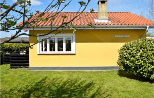 a yellow house with a red roof at Solvang in Otterup +6 photos