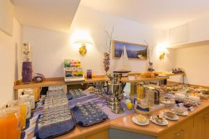 a room with a counter with a table filled with items at Villa Osada in Binz