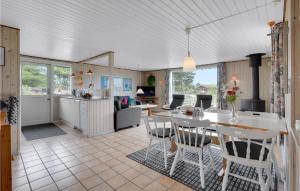 a kitchen and living room with a table and chairs at Cozy Home In Rm With Wifi in Bolilmark
