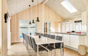 a dining room with a white table and chairs at Cozy Home In Bogense With Sauna in Bogense