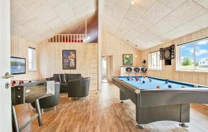 a billiard room with a pool table and chairs at Nice Home In Bogense With Sauna, Wifi And Indoor Swimming Pool in Bogense