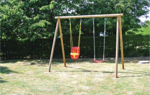 an empty swing set in a park at Holiday Home Kamillevej Tranekær X in Skattebølle
