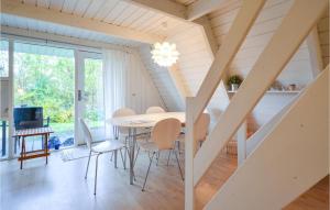 a dining room with a table and chairs at Beautiful Home In Knebel With Outdoor Swimming Pool in Knebel