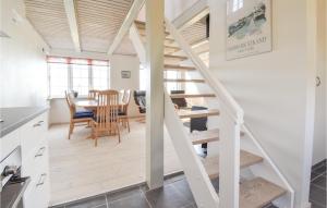 eine Küche und ein Esszimmer mit einer Treppe in einem winzigen Haus in der Unterkunft Katholt in Otterup